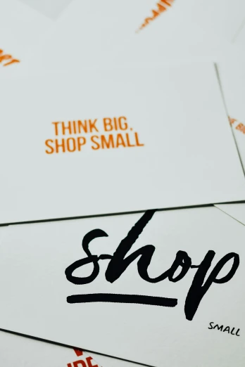 a pile of business cards sitting on top of each other, a screenprint, by Sam Black, trending on unsplash, mail art, shop front, snail, style lettering, 3 / 4 wide shot