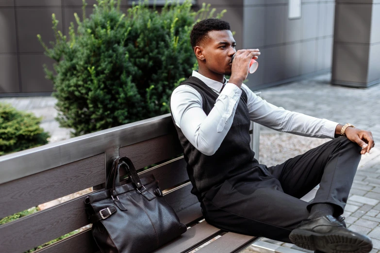 a man sitting on a bench drinking water, happening, tailored clothing, man is with black skin, cold brew coffee ), wearing a vest and a tie