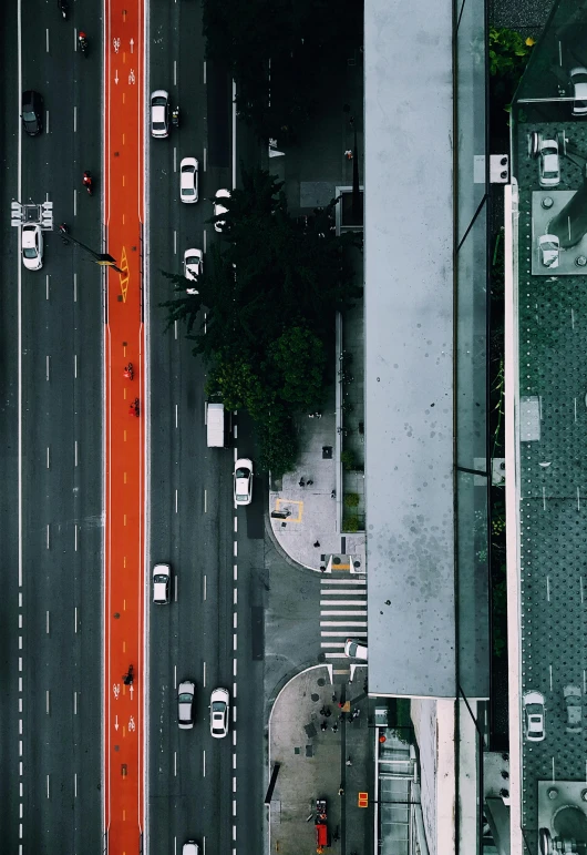 a street filled with lots of traffic next to tall buildings, a screenshot, unsplash contest winner, top down view, gray and orange colours, square, color footage