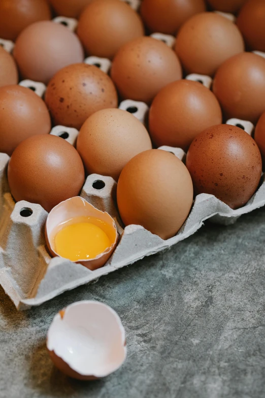 a carton filled with eggs sitting on top of a table, trending on pexels, renaissance, ingredients on the table, ( 3 1, australian, up close