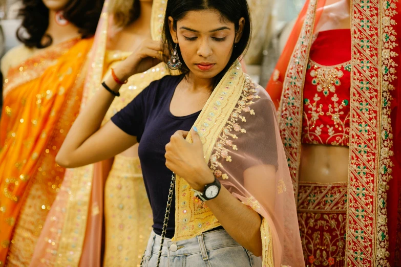 a woman adjusts a blouse on a mannequin mannequin mannequin mannequin mannequin mannequin manne, pexels, dressed in a sari, thumbnail, wearing a crop top, holding a gold bag