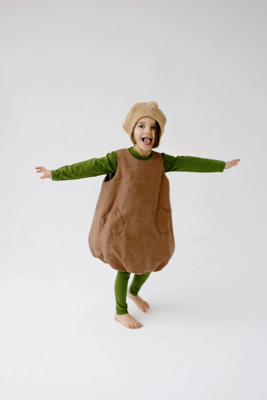 a small child in a costume on a white background, an album cover, pexels, peter dutton as a potato, green and brown clothes, photo taken in 2 0 2 0, npr