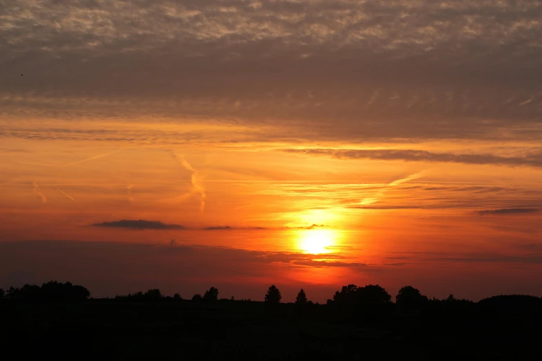 the sun is setting behind the clouds in the sky, a picture, by Jan Tengnagel, pexels contest winner, romanticism, hot summer day, low quality photo, over the horizon, no cropping