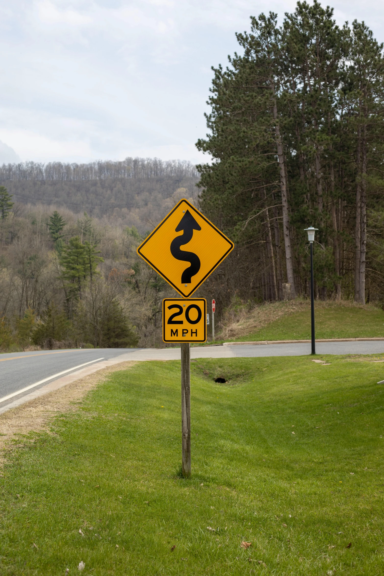 a yellow sign sitting on the side of a road, by Jeffrey Smith, winding rivers, twenty-dimensional, wisconsin, splash image