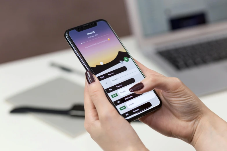 a close up of a person holding a cell phone, trending on pexels, on desk, highly detailed rounded forms, oled, loadscreen”