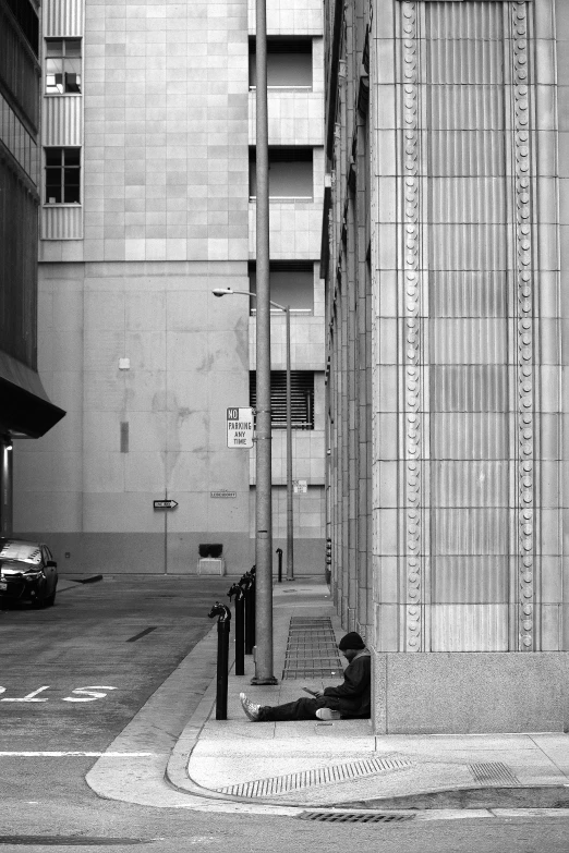 a black and white photo of a person sitting on a bench, inspired by Vivian Maier, brutalism, location [ chicago ( alley ) ], los angeles 2 0 1 5, square lines, parked cars