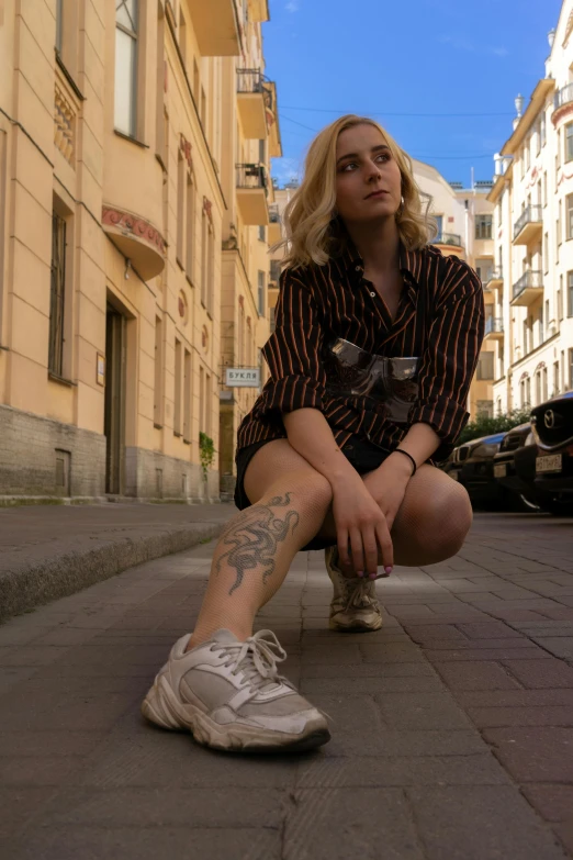 a woman sitting on the side of a street, an album cover, inspired by Elsa Bleda, pexels contest winner, hyperrealism, attractive androgynous humanoid, in moscow centre, saoirse ronan, sneakers