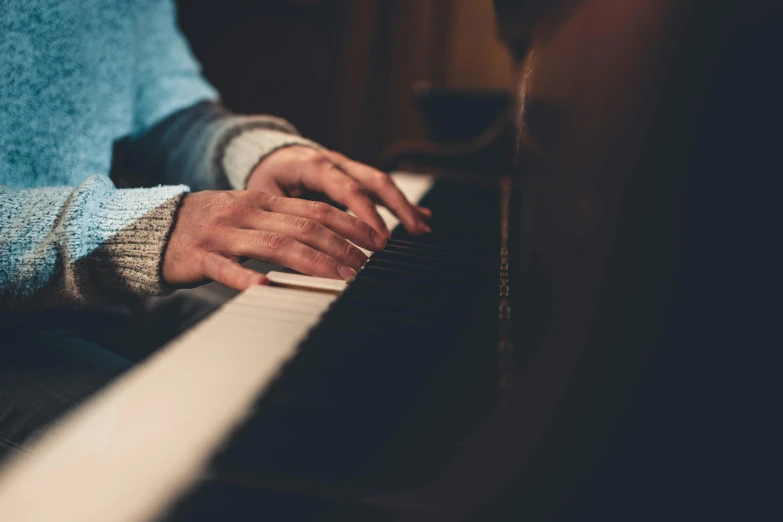 a close up of a person playing a piano, by Matt Cavotta, trending on pexels, digitally remastered, cozy setting, multiple stories, mid shot portrait