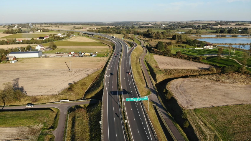 an aerial view of a highway in a rural area, by Julian Allen, 15081959 21121991 01012000 4k, high resolution ultradetailed, thumbnail, alex heywood