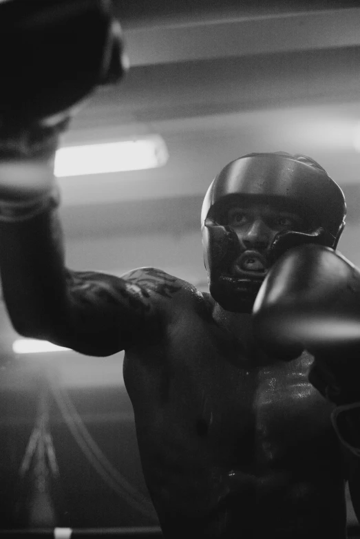 a black and white photo of a man in a boxing ring, pexels contest winner, photorealism, 2 0 2 1 cinematic 4 k framegrab, helmet view, still from a music video, octane cgsociety