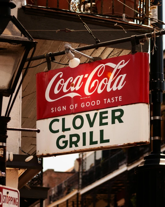 a coca cola sign hanging from the side of a building, poster art, by Jacob Collins, pexels contest winner, big nebula as clover, new orleans, grill, food stall