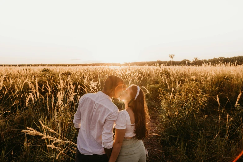 a couple kissing in a field of tall grass, pexels contest winner, happening, looking onto the horizon, warm glow, instagram post, profile image