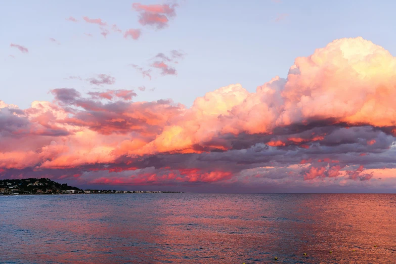 a large body of water under a cloudy sky, a picture, pexels contest winner, romanticism, orange / pink sky, cyprus, panoramic, manly