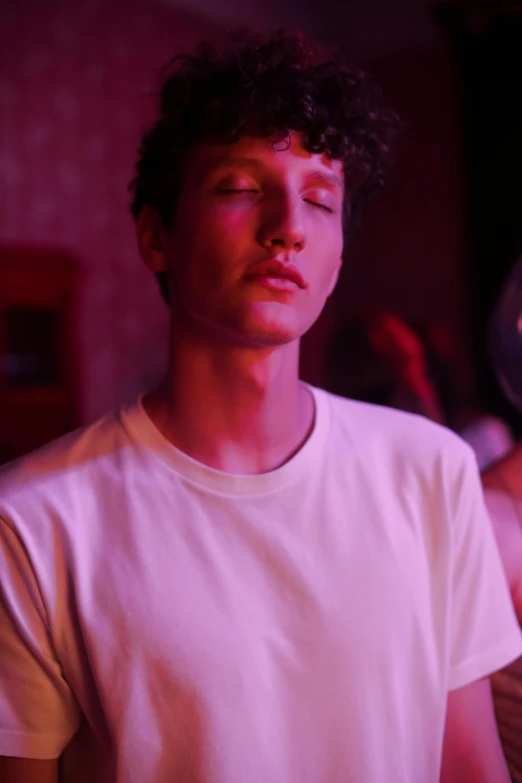 a man standing next to a woman in a room, an album cover, inspired by Nan Goldin, trending on unsplash, renaissance, 1 7 - year - old boy thin face, meditating, ( ( theatrical ) ), thick jawline