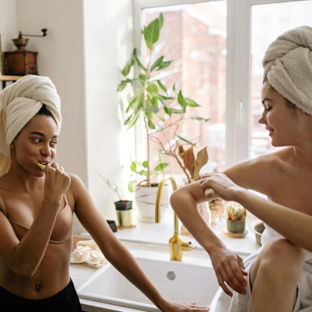 a couple of women sitting next to each other in a bathroom, millennial vibes, smelling good, body hair, afternoon hangout