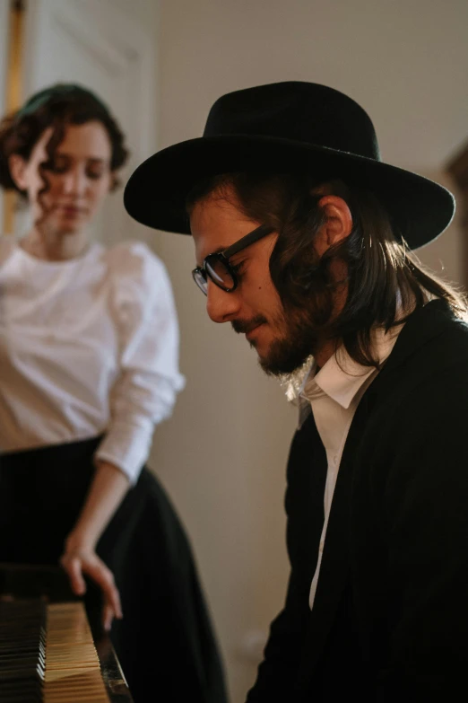 a man and a woman playing a piano, an album cover, by Elias Goldberg, trending on unsplash, jewish young man with glasses, whirling, with hat, profile image