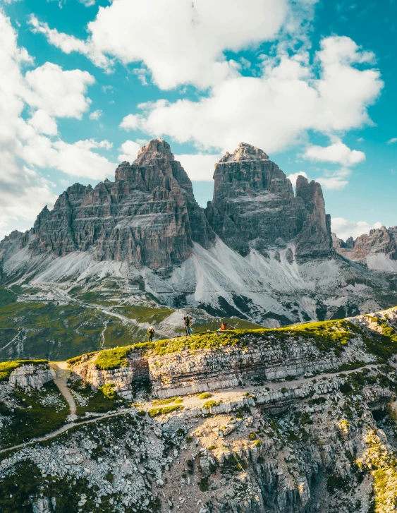 a view of the mountains from the top of a mountain, a matte painting, pexels contest winner, dolomites, three towers, looking towards camera, gigapixel photo