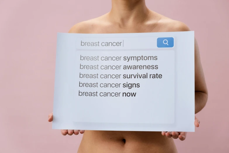 a woman holding a sign that reads breast cancer symptoms breast cancer awareness breast cancer survival rate breast cancer signs breast cancer now, a photo, by Ellen Gallagher, trending on pexels, renaissance, made of glazed, breasts covered and sfw, panoramic shot, high resolution print :1 cmyk :1