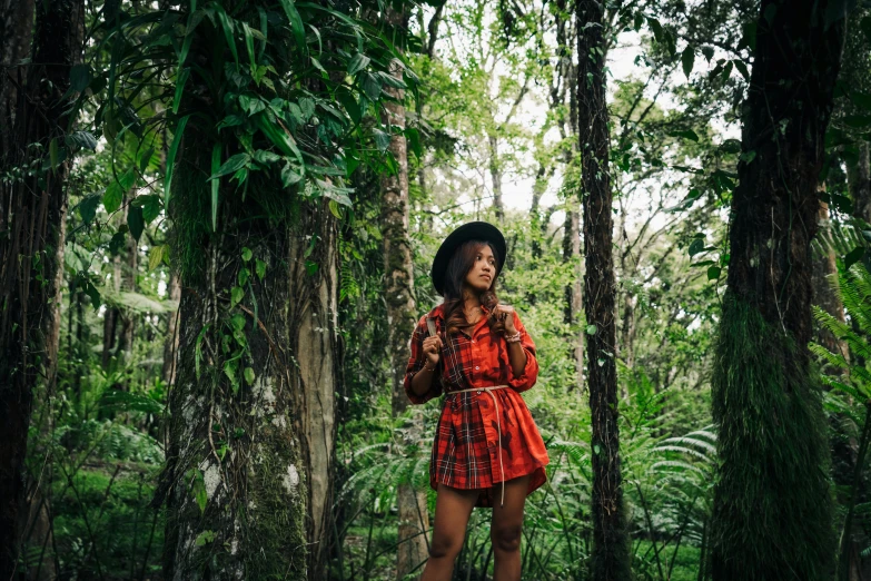 a woman standing in the middle of a forest, a portrait, by Julia Pishtar, sumatraism, wearing a red plaid dress, big island, avatar image, conde nast traveler photo