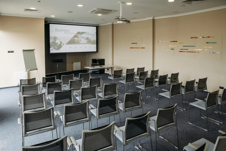 a room filled with chairs and a projector screen, central hub, birdseye view, quiet beauty, professional artwork