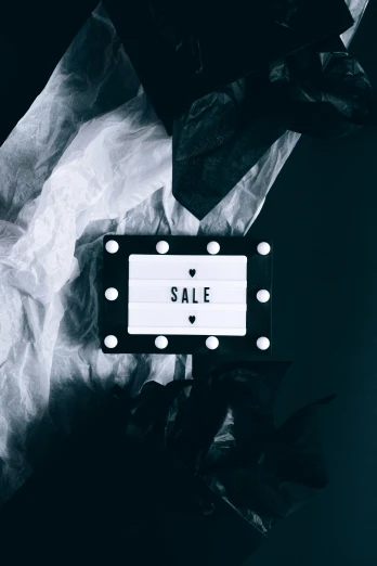 a black and white photo of a sale sign, trending on unsplash, visual art, fancy dress, lights on, instagram story, flat lay