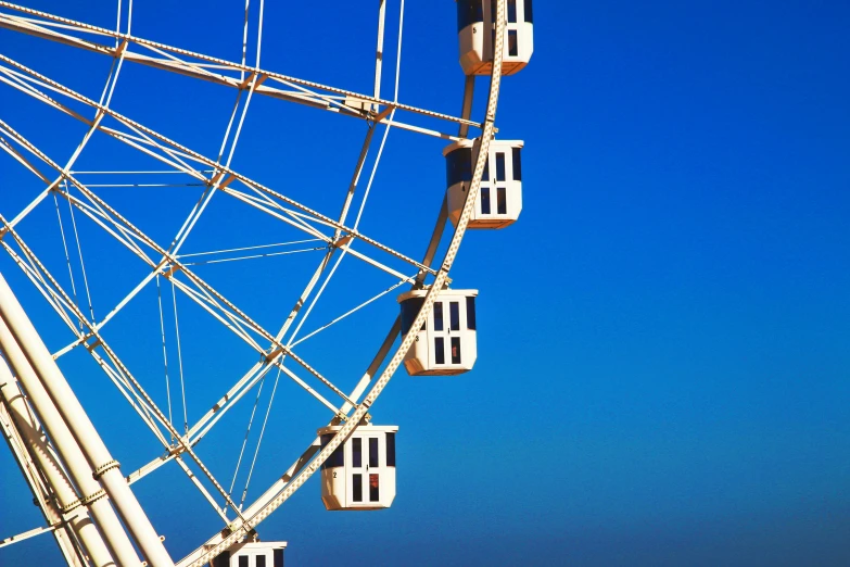 a ferris wheel in front of a blue sky, a photo, by Niko Henrichon, romanticism, 3 4 5 3 1, azure blue sky, albino, wheels