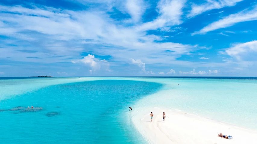 a group of people standing on top of a sandy beach, light blue water, bottom of the ocean, turquoise, cosmopolitan