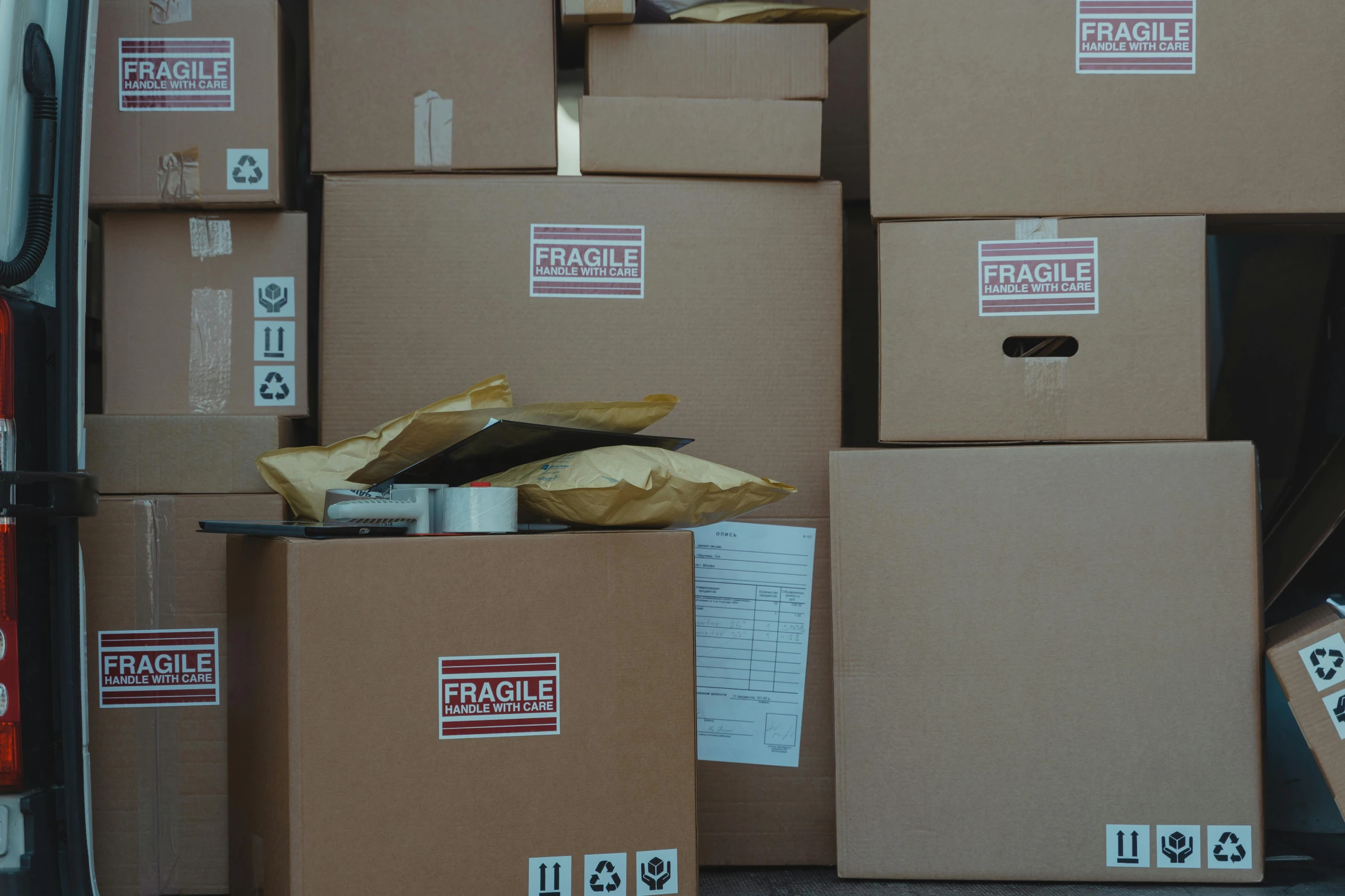 a bunch of boxes sitting in the back of a van, background image, curated collections, brown, labelled