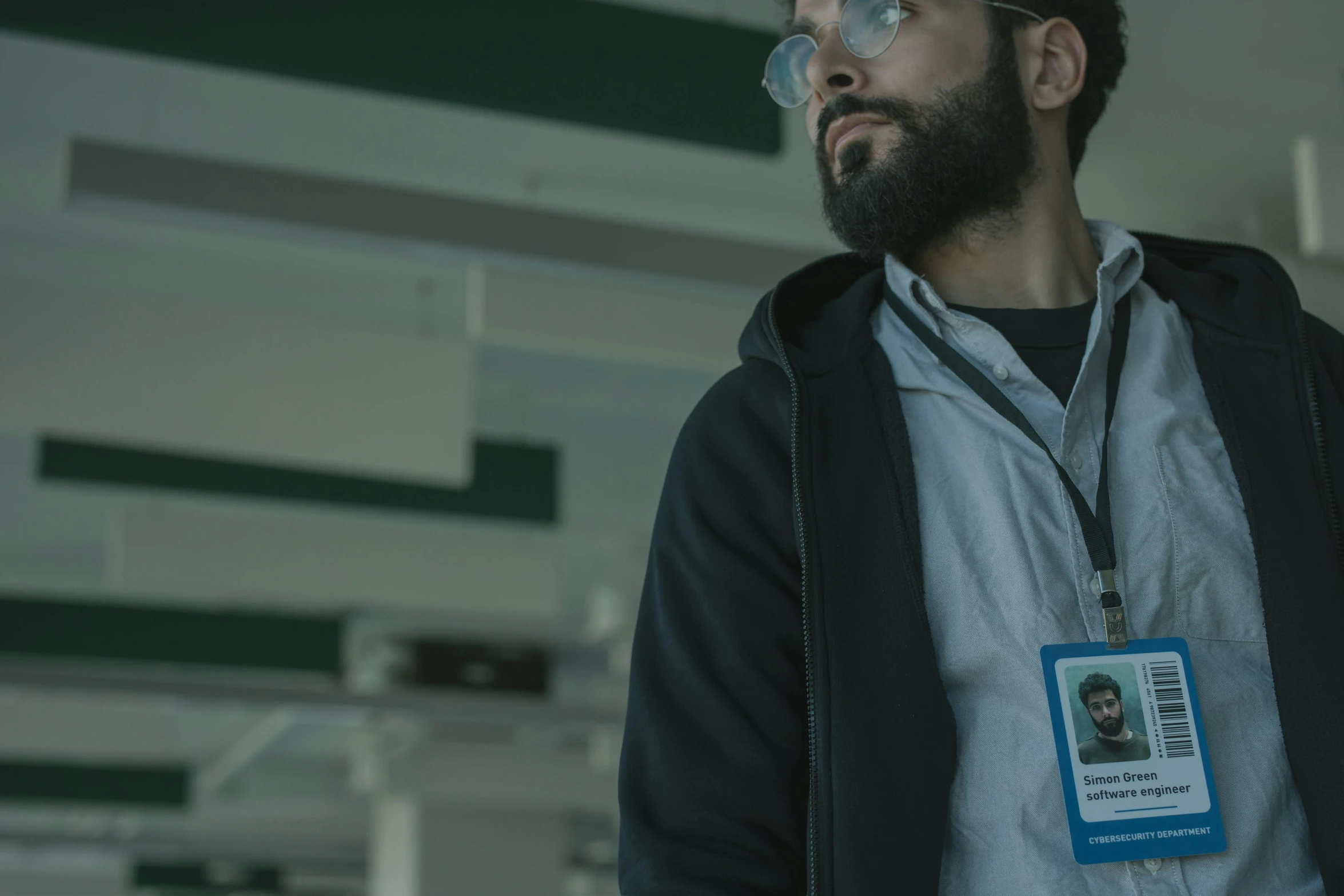 a man with a beard wearing glasses and a name tag, by Alejandro Obregón, pexels contest winner, serial art, cinematic scifi shot, an arab standing watching over, in a research facility, security agent