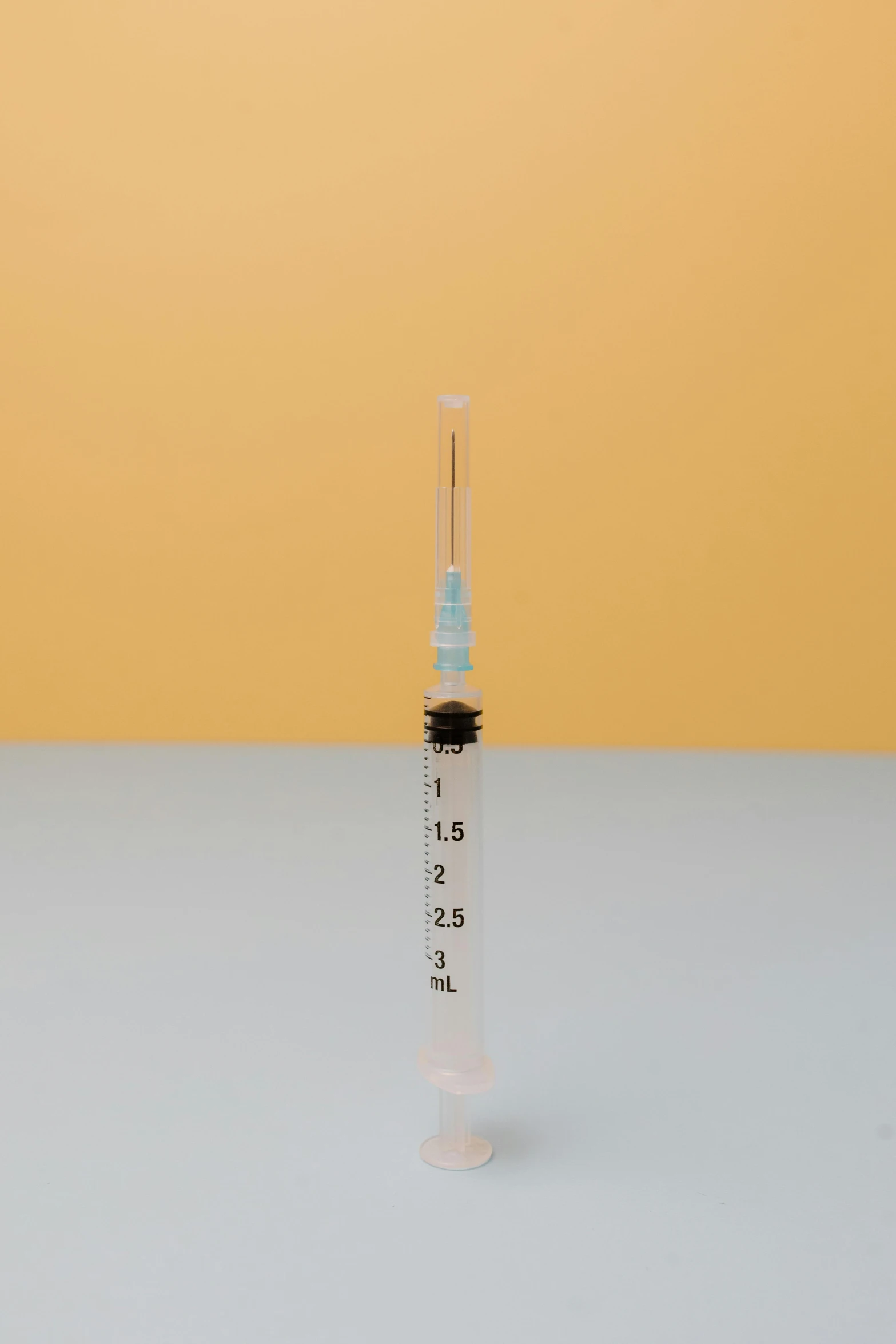 a syll sitting on top of a table, syringe, detailed product image, straight smooth vertical, 45 degrees from the side