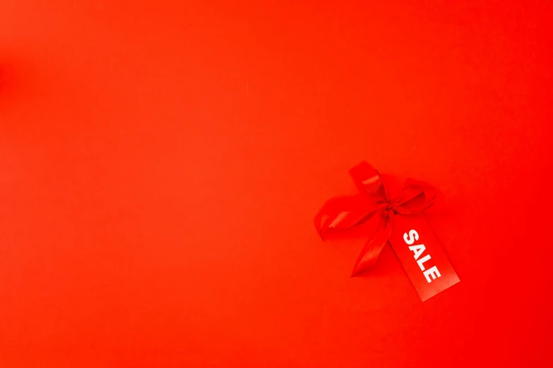 a red gift box with a red bow on a red background, by Julia Pishtar, pexels contest winner, minimalism, advert, tag, sales, graphic print