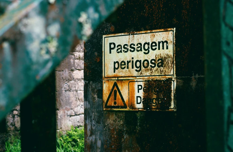 a sign that is on the side of a building, by Elsa Bleda, pexels, inside a gorge, parce sepulto, poisonous, overpass