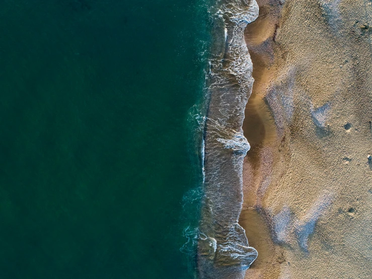 a large body of water next to a sandy beach, by Julian Allen, unsplash contest winner, abstract edges, birdseye view, split in half, fine detail post processing