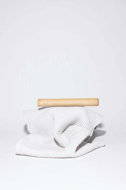 a white towel with a wooden handle on a white surface, unsplash, detailed product image, carbon, various sizes, curated collection