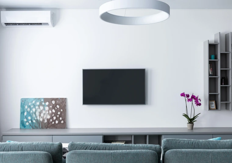 a living room filled with furniture and a flat screen tv, inspired by Telemaco Signorini, pexels contest winner, minimalism, air conditioner, white ceiling, flat grey color, high - definition picture