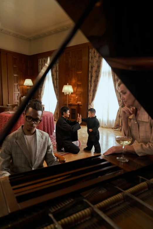 a group of people sitting around a piano, in style of joel meyerowitz, luxurious environment, performing a music video, in the white house