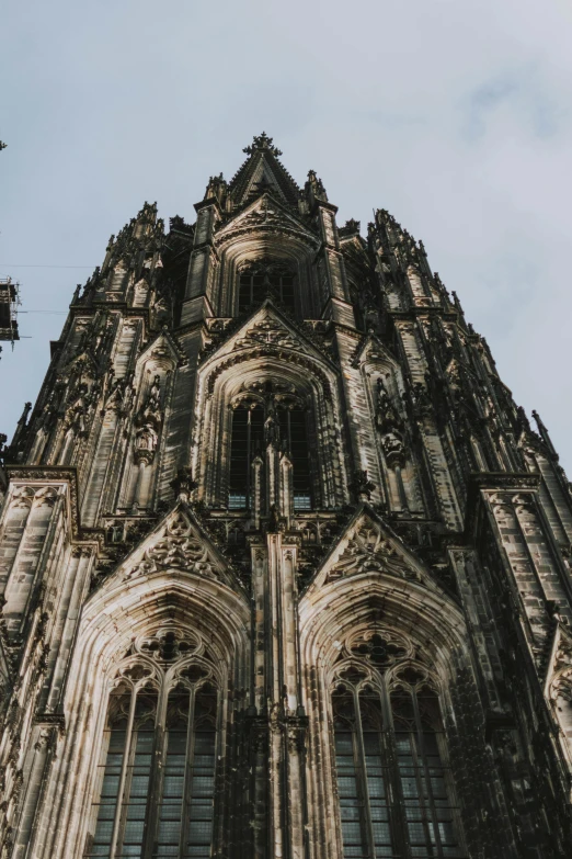 a tall building with a clock on top of it, pexels contest winner, baroque, gothic cathedral, germany. wide shot, towering high up over your view, detailed faces looking up