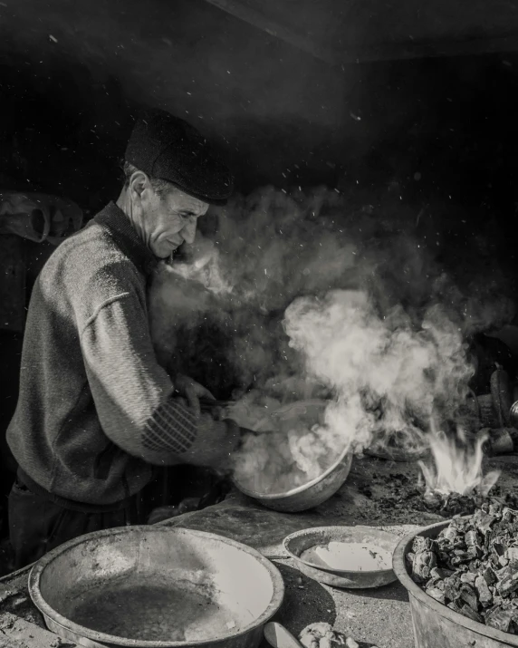 a black and white photo of a man cooking food, by Abdullah Gërguri, pexels contest winner, winter, woodfired, ilustration, chinese