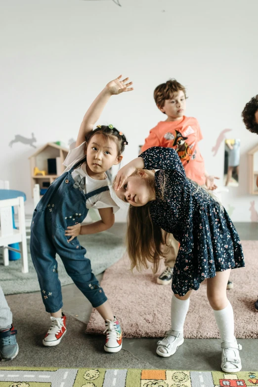 a group of children playing a game of hop hop hop hop hop hop hop hop hop hop hop hop hop hop hop hop hop hop hop hop, by Arabella Rankin, pexels contest winner, interactive art, distorted pose, kawaii playful pose of a dancer, studio photo, highly disturbing