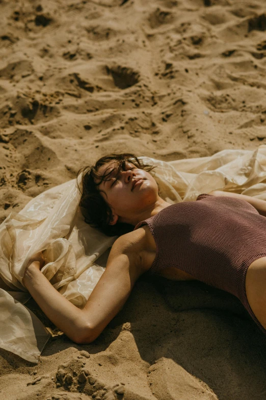 a woman laying on top of a sandy beach, inspired by Elsa Bleda, pexels contest winner, renaissance, film still from movie dune-2021, cute girl wearing tank suit, ignant, belgium