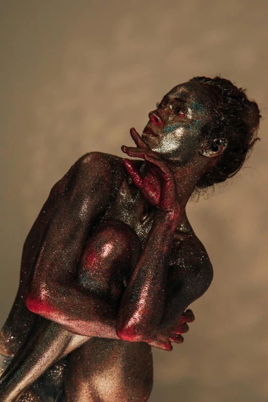 a naked woman with silver paint on her body, inspired by Bert Stern, pexels contest winner, figurative art, brown red blue, made of tar, dark skin, resin statue