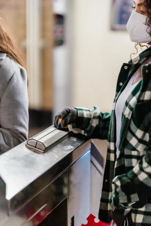 a couple of women standing next to each other, trending on pexels, happening, pair of keycards on table, in a subway, thumbnail, exiting store