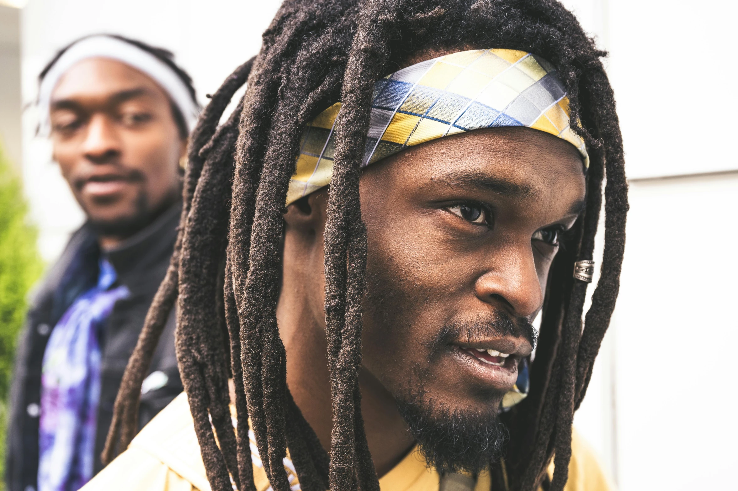 two men with dreadlocks standing next to each other, pexels contest winner, hurufiyya, wearing a headband, aaron sims, photo from a spectator, close up of face