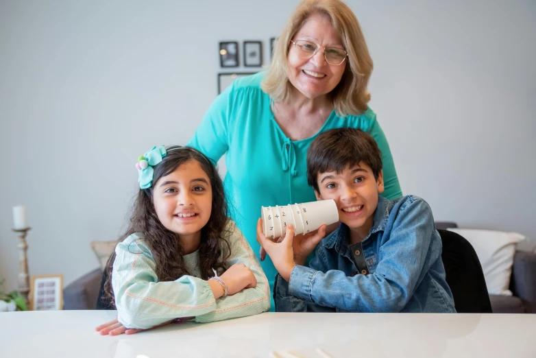 a woman and two children sitting at a table, pexels contest winner, ashcan school, modelling clay, greek ameera al taweel, with a whitish, full device