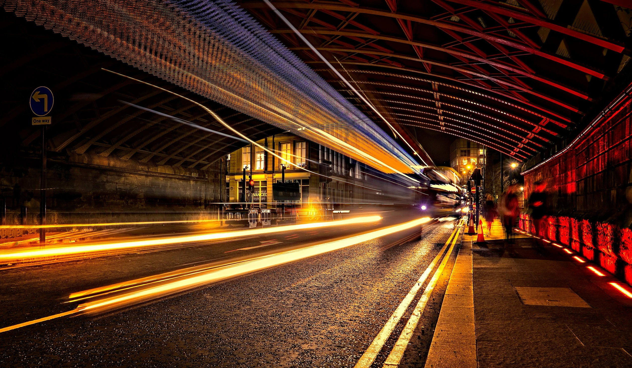 a train traveling down a train track at night, by Andrew Allan, pexels contest winner, sweeping arches, bus station, thumbnail, vibrant light