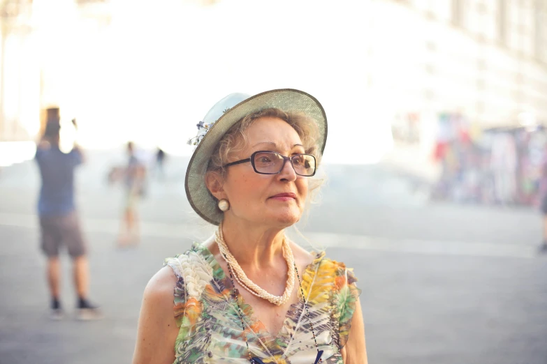 an older woman wearing a hat and glasses, pexels contest winner, renaissance, in a city square, avatar image, naples, short