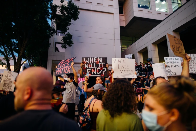 a group of people holding signs in front of a building, by Meredith Dillman, pexels, renaissance, summer evening, square, protest, panel of black