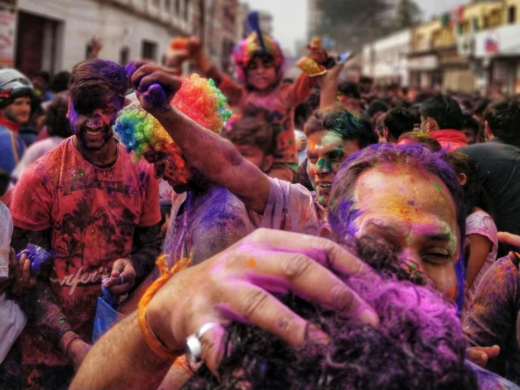 a crowd of people covered in colored powder, a photo, by Sam Dillemans, pexels contest winner, action painting, on an indian street, gopro footage, 🎨🖌, elaborate hair