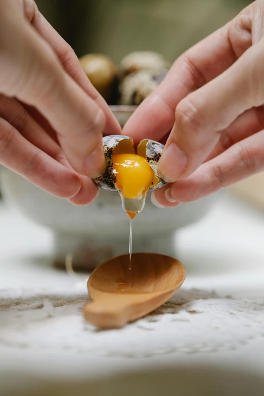 a person peeling an egg with a wooden spoon, abalone, raw egg yolks, avatar image, julia sarda