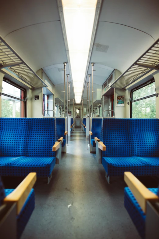 the inside of a train car with blue seats, by karlkka, unsplash, panorama, 2 5 6 x 2 5 6 pixels, summer morning, around the city